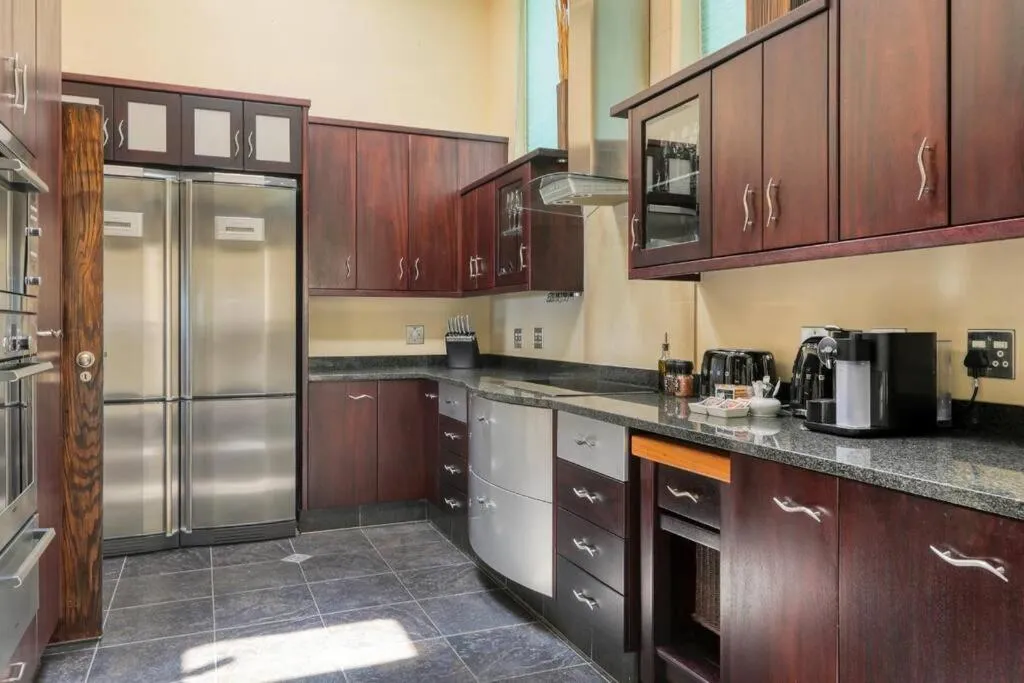 Kitchen with dark timber cabinetry and a double fridge
